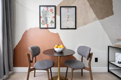 a table with chairs and a bowl of fruit on it at François-Denis Apartments in Montréal