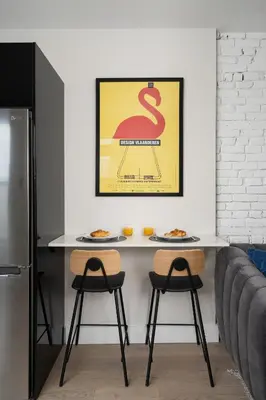 a kitchen with a table and two stools with food at François-Denis Apartments in Montréal