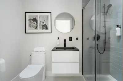 a bathroom with a toilet and a sink and a shower at François-Denis Apartments in Montréal