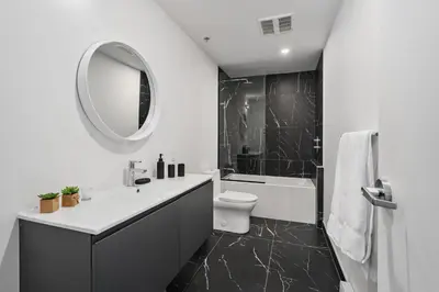 a bathroom with a sink and a toilet and a mirror at Bakan - Sainte Catherine in Montréal
