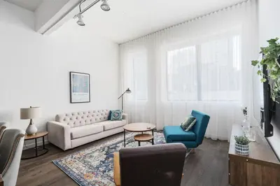 a living room with a couch and chairs and a table at Bakan - Sainte Catherine in Montréal