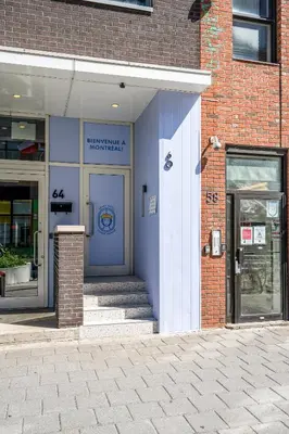 a building with a blue door on the side of it at Hotel-Apart Prince Arthur in Montréal