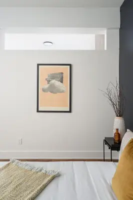 a bedroom with white walls and a bed at Hotel-Apart Prince Arthur in Montréal