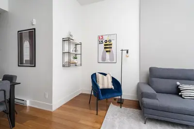 a living room with a couch and a chair at Hotel-Apart Prince Arthur in Montréal