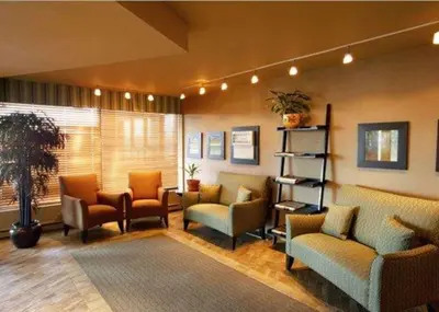 a waiting room with couches and chairs at Quality Inn & Suites PE Trudeau Airport in Dorval