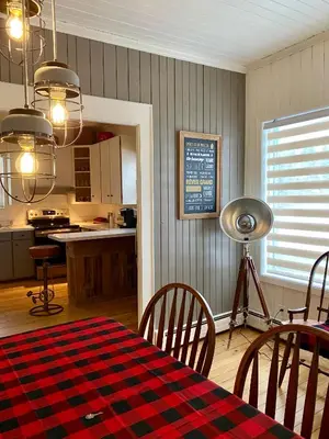 a kitchen and dining room with a table and chairs at Bel appartement A la croisée des sommets in Notre-Dame-Des-Bois