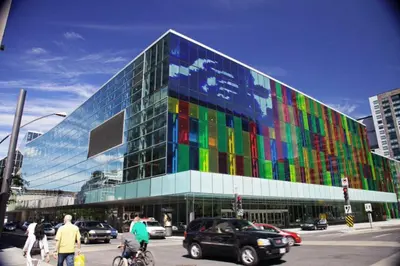 a large glass building with a colorful facade at Bakan- Quartier des Congres, Convention District in Montréal