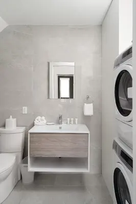 a bathroom with a sink and a washing machine at Bakan- Quartier des Congres, Convention District in Montréal