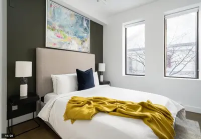 a bedroom with a bed with a yellow blanket on it at Bakan- Quartier des Congres, Convention District in Montréal