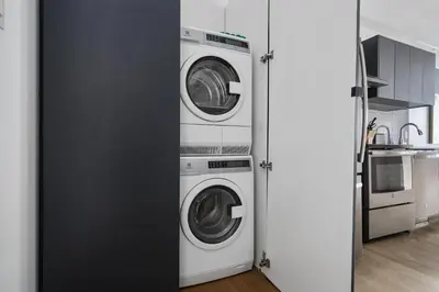 a kitchen with two washer and dryer in a room at Bakan- Quartier des Congres, Convention District in Montréal