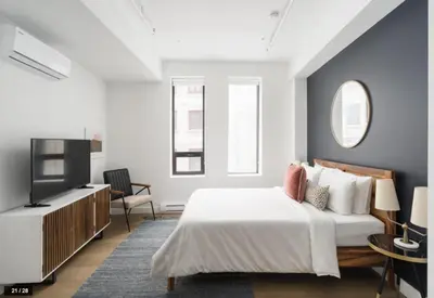 a bedroom with a bed and a flat screen tv at Bakan- Quartier des Congres, Convention District in Montréal