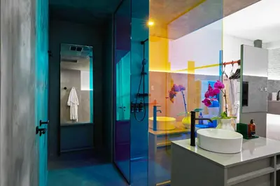 a colorful bathroom with a sink and a shower at David Hotel in Montréal