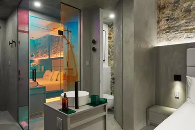a bathroom with a tub and a sink and a mirror at David Hotel in Montréal