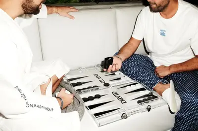 two men sitting in the back of a boat with a wine rack at David Hotel in Montréal