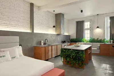a bedroom with a bed and a kitchen with a counter at David Hotel in Montréal