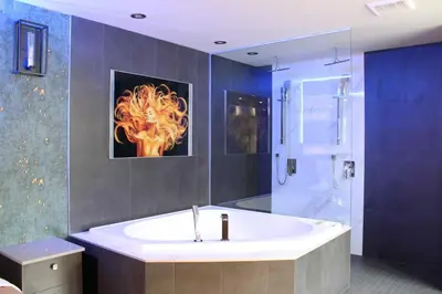 a bathroom with a tub and a shower and a sink at Olux Hotel-Motel-Suites in Laval