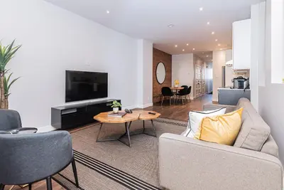 a living room with a couch and a table at Vast and perfectly located 3 bedroom flat by DenStays in Montréal