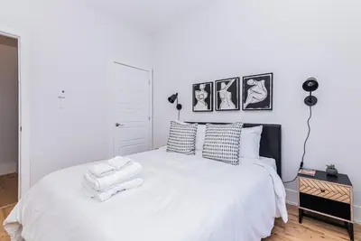 a bedroom with a white bed with two towels on it at New classy 2 bedroom apartment in Le Plateau by DenStays in Montréal