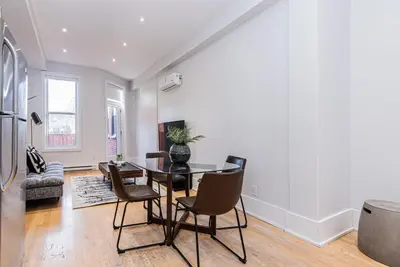 a dining room with a table and chairs at New classy 2 bedroom apartment in Le Plateau by DenStays in Montréal