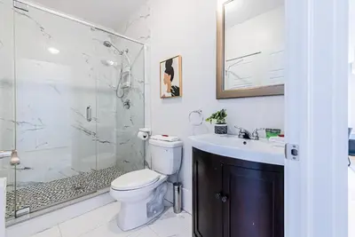 a bathroom with a toilet and a shower and a sink at New classy 2 bedroom apartment in Le Plateau by DenStays in Montréal