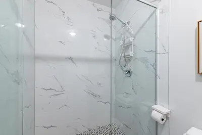 a shower with a glass door in a bathroom at New classy 2 bedroom apartment in Le Plateau by DenStays in Montréal