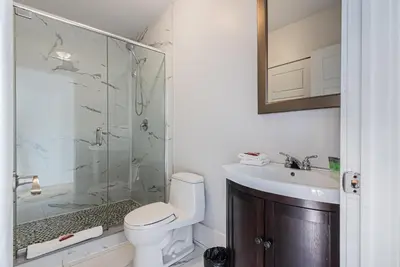 a bathroom with a shower and a toilet and a sink at Welcoming and Homey unit near Mount Royal by DenStays in Montréal