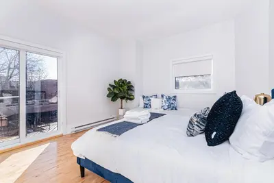 a bedroom with a large bed with pillows and a window at Welcoming and Homey unit near Mount Royal by DenStays in Montréal
