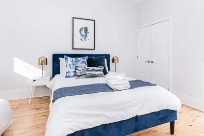 a bedroom with a blue and white bed at Welcoming and Homey unit near Mount Royal by DenStays in Montréal