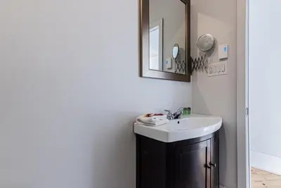 a bathroom with a sink and a mirror at Welcoming and Homey unit near Mount Royal by DenStays in Montréal
