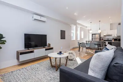 a living room with a couch and a tv at Welcoming and Homey unit near Mount Royal by DenStays in Montréal