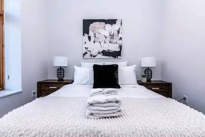 a bedroom with a white bed with a blanket on it at Massive 3 bedroom apartment in the hearth of Le Plateau by DenStays in Montréal