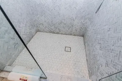 an overhead view of a bathroom with a tiled floor at Massive 3 bedroom apartment in the hearth of Le Plateau by DenStays in Montréal