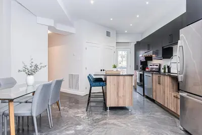 a kitchen with a table and chairs and a refrigerator at Massive 3 bedroom apartment in the hearth of Le Plateau by DenStays in Montréal