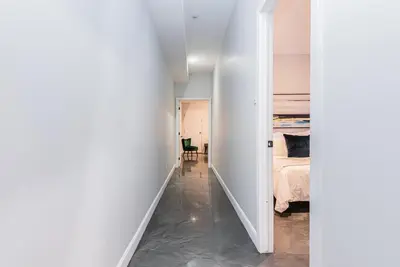 a hallway leading to a bedroom with a bed at Massive 3 bedroom apartment in the hearth of Le Plateau by DenStays in Montréal