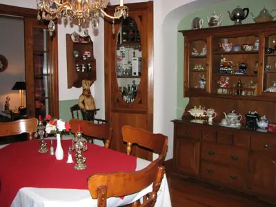 a dining room with a table and a chandelier at Magnolia B&B in Granby