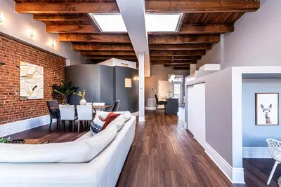 a living room with a white couch and a brick wall at Family Friendly 3-bedroom beauty in Le Plateau by DenStays in Montréal