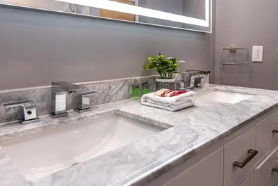 a white bathroom with two sinks and a mirror at Family Friendly 3-bedroom beauty in Le Plateau by DenStays in Montréal