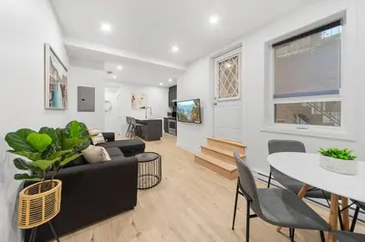 a living room with a couch and a table at Stonewall Suites in Montréal