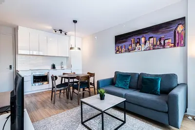 a living room with a blue couch and a table at WERFY Luxury Apart-Hotel in Montréal