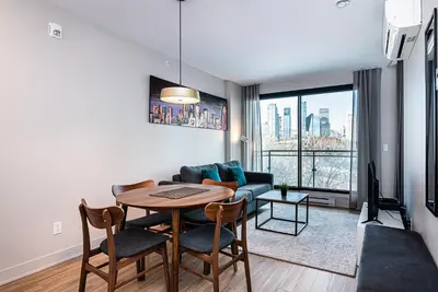 a living room with a table and a couch at WERFY Luxury Apart-Hotel in Montréal