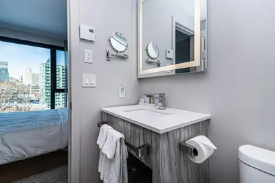 a bathroom with a sink and a mirror at WERFY Luxury Apart-Hotel in Montréal