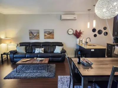 a living room with a couch and a table at Le 201 Champlain Bromont in Bromont