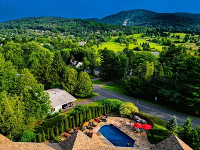 an aerial view of a resort with a pool and trees at Le 201 Champlain Bromont in Bromont