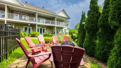 a group of chairs sitting in front of a house at Le 201 Champlain Bromont in Bromont