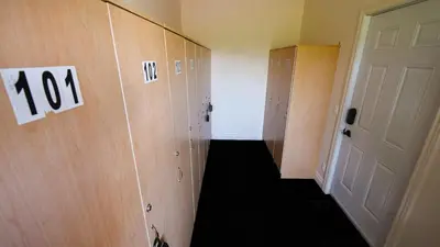 a hallway with lockers and a door in a room at Le 201 Champlain Bromont in Bromont