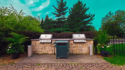 a grill with two burners on a brick wall at Le 201 Champlain Bromont in Bromont