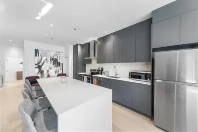 a kitchen with a white counter and a refrigerator at Suites De la Montagne in Montréal