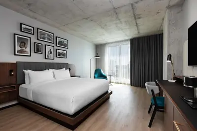 a hotel room with a large bed and a desk at Hyatt Centric Montreal in Montréal