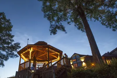 a gazebo with lights on it at night at L'Auberge Du Lac St-Pierre in Trois-Rivières