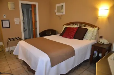 a bedroom with a large bed with red pillows at Motel Derfal in Repentigny